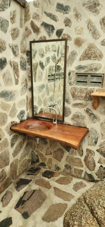 a mirror on a wooden shelf on a stone wall at Why Nam Beach in Haad Yuan