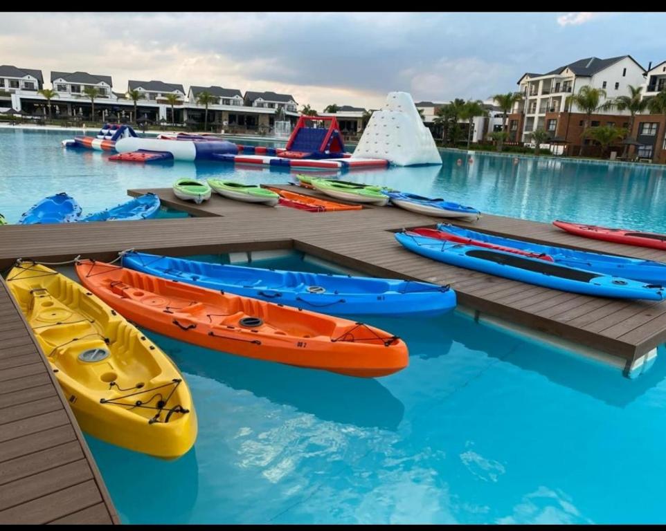 a group of kayaks on a dock in a pool at The Blyde Crystal Lagoon in Pretoria