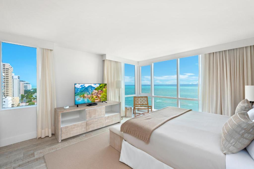 a hotel room with a bed and a television at Oceanfront Private Condo at 1 Hotel & Homes -1219 in Miami Beach