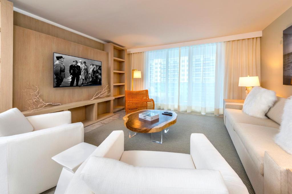 a living room with a white couch and a table at Oceanview Private Condo at 1 Hotel & Homes -1106 in Miami Beach