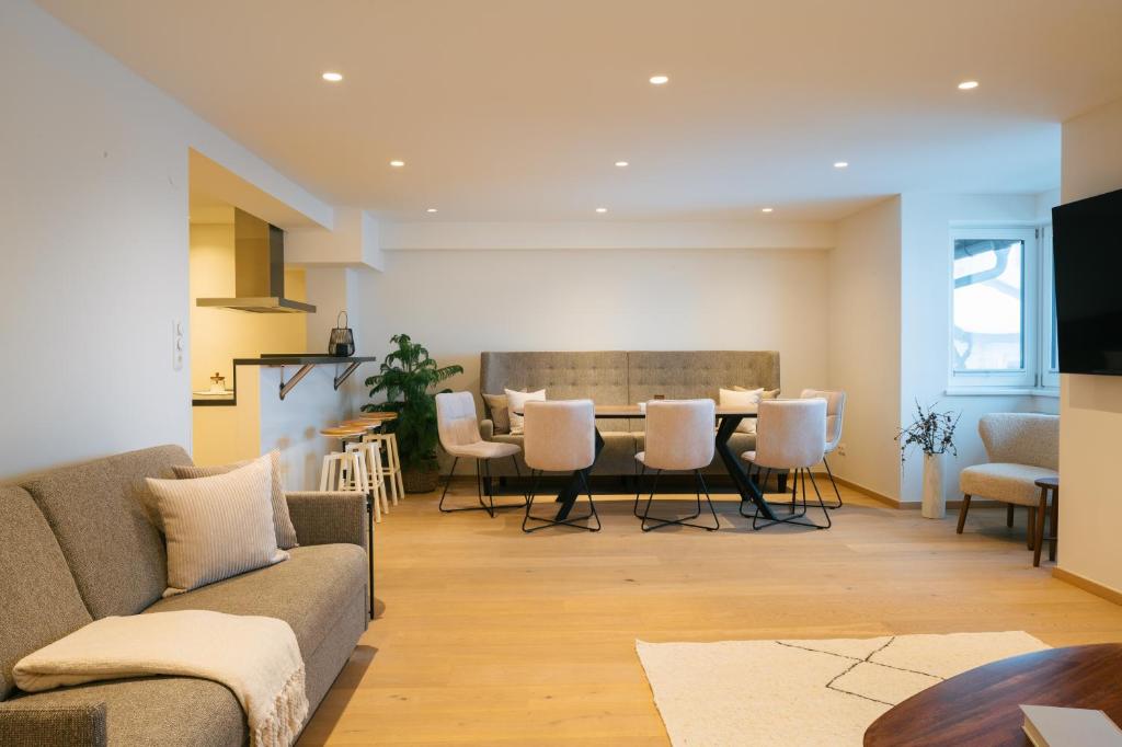 a living room with a couch and a table and chairs at Boutique Apart Serfaus in Serfaus