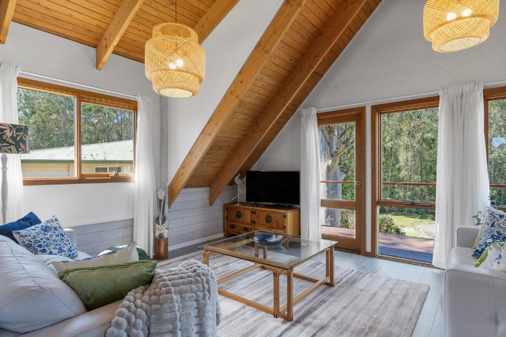 a living room with a couch and a table at The Beach Haven in Bawley Point