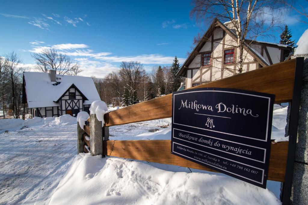 a sign in the snow in front of a house at Milkowa Dolina in Szklarska Poręba