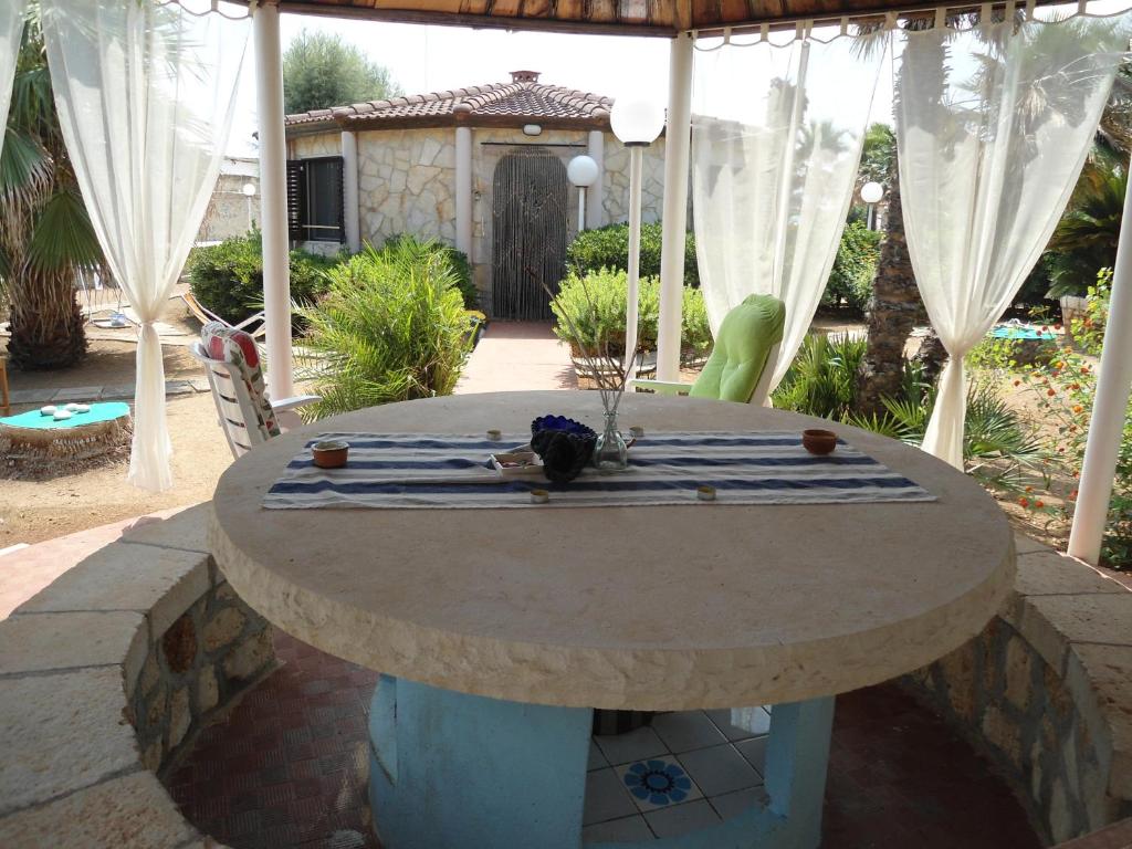 a stone table in a patio with a tableablish at Ville Alba & Azzurra in Polignano a Mare