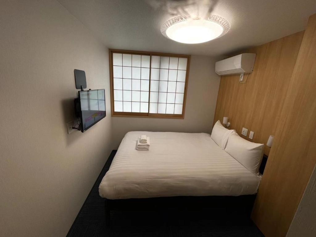 Säng eller sängar i ett rum på Oda hotel Akihabara
