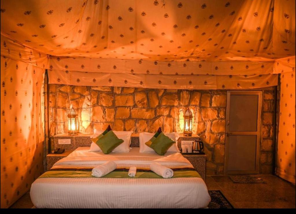 a bedroom with a large bed in a tent at Jaisal heritage desert camp in Jaisalmer