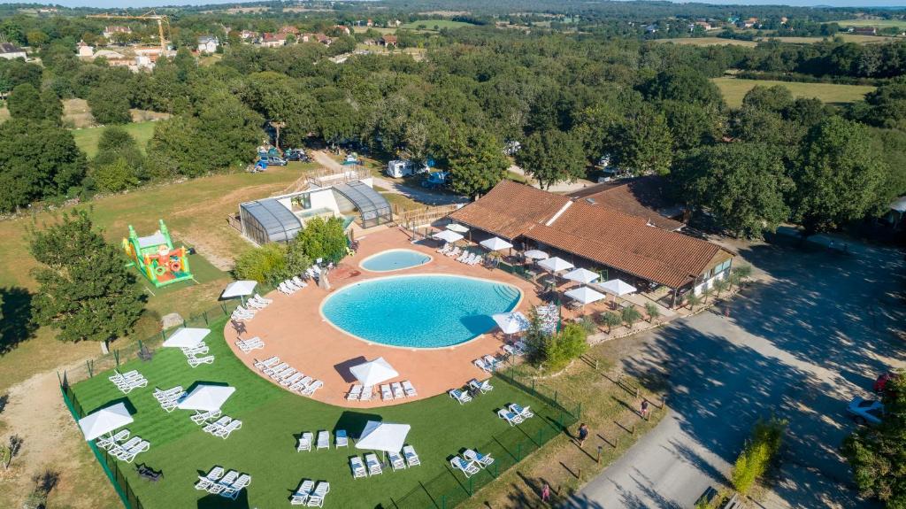 an aerial view of a resort with a swimming pool at Camping les Cigales Rocamadour in Rocamadour