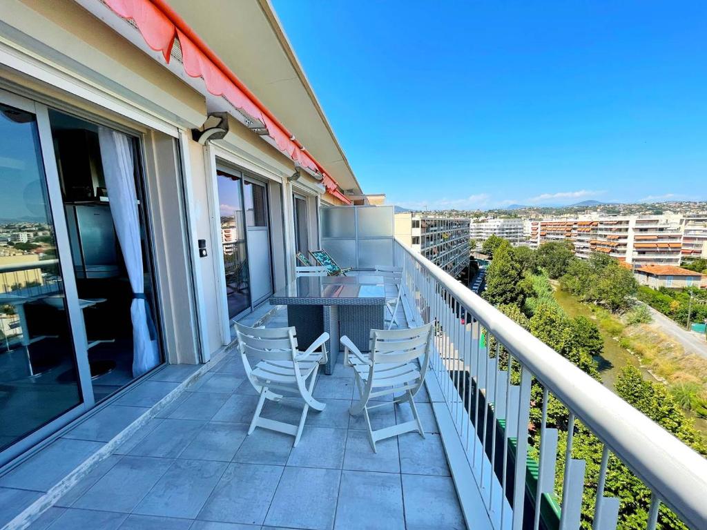 a balcony with chairs and a table with a view at Le Chaville in Cagnes-sur-Mer