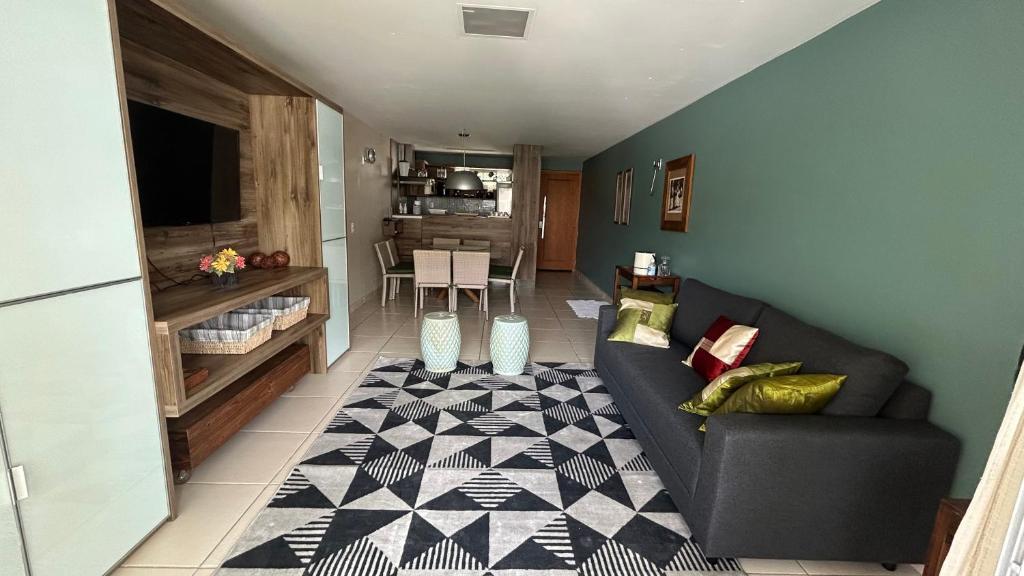 a living room with a couch and a rug at Apartamento Imperial Porto Brasil in Pirangi do Norte