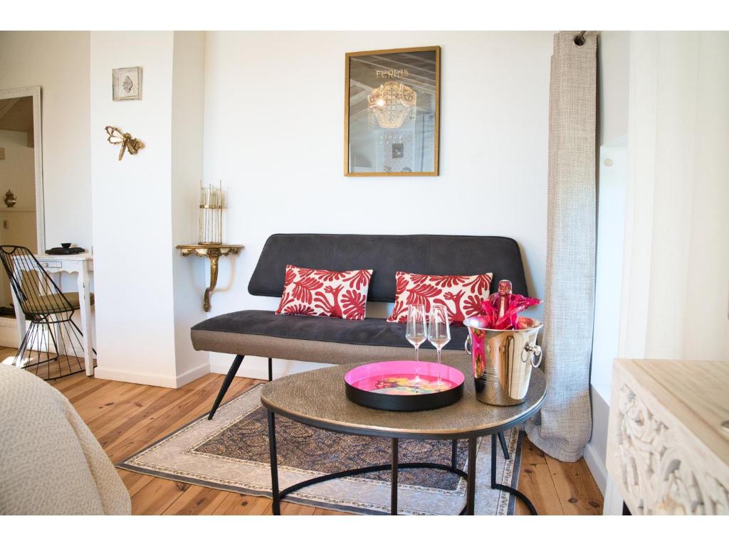 a living room with a couch and a table at Le Mas des Aires - Chambres d&#39;Hôtes - Blauzac -Uzès - Pont du Gard in Blauzac