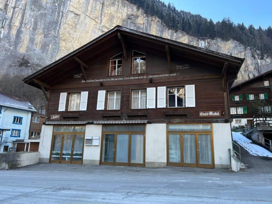 a building in front of a mountain at Chalet Maithili Lauterbrunnen -152-Year-Old Majestic Chalet in Lauterbrunnen