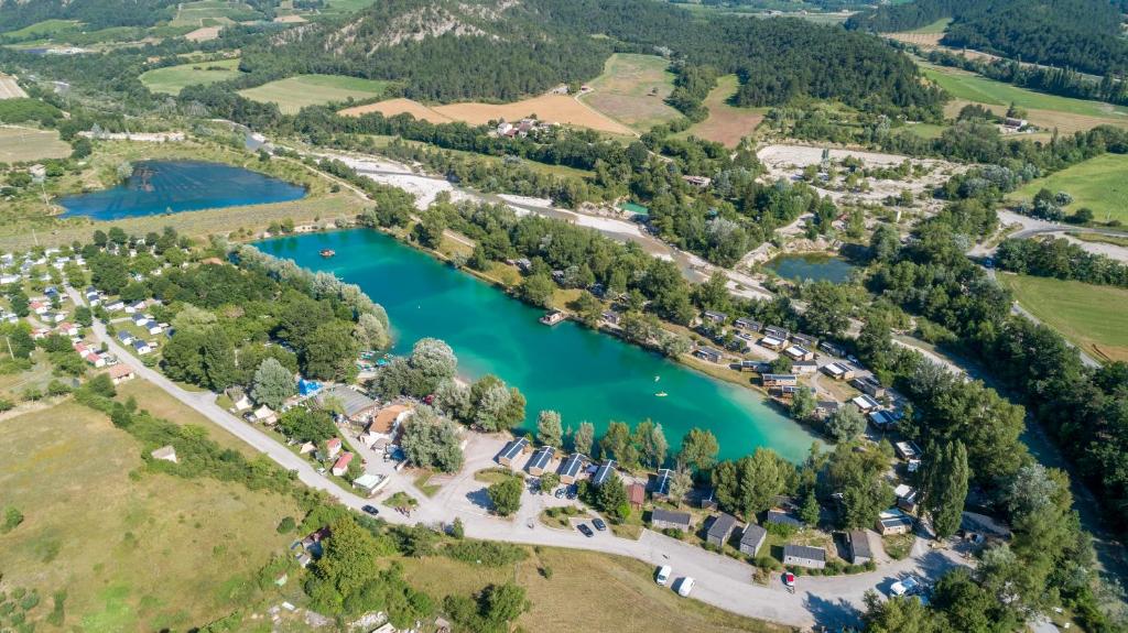 an aerial view of a park with a lake at Camping Le Lac Bleu in Châtillon-en-Diois