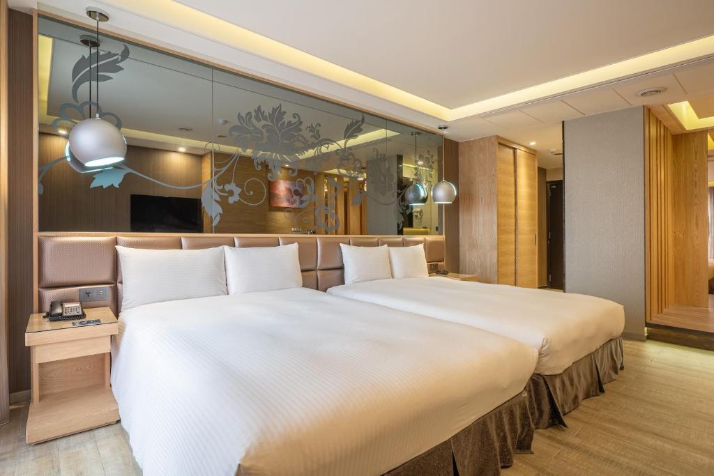 Postel nebo postele na pokoji v ubytování Guide Hotel Taichung Ziyou
