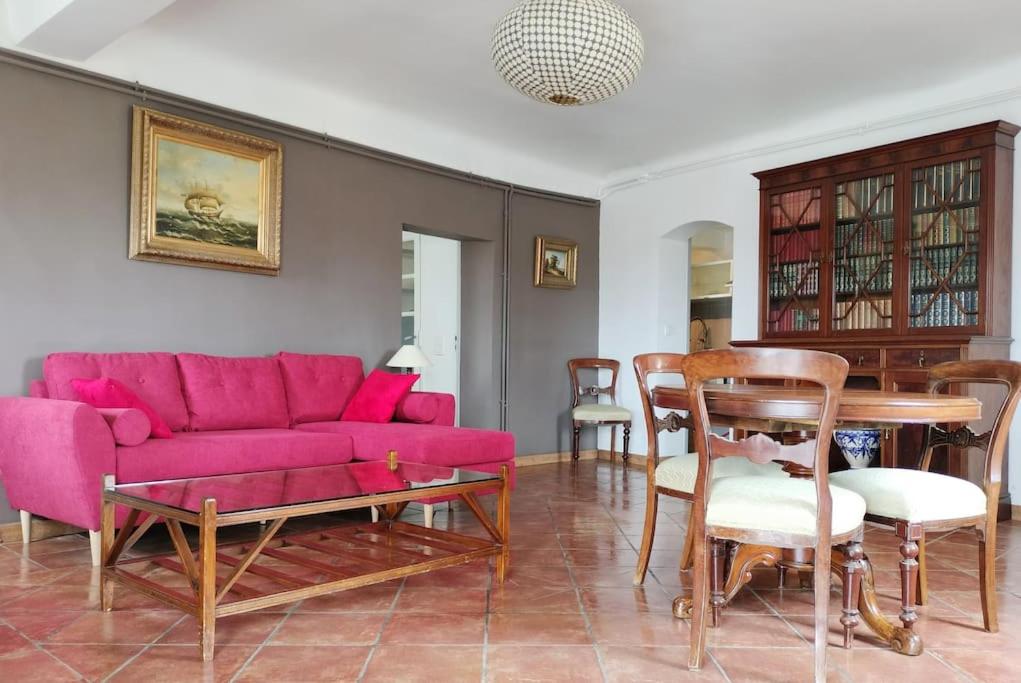 un salon avec un canapé rose et une table dans l'établissement Superbe T3 avec terrasse en plein cœur du centre historique, à Aix-en-Provence