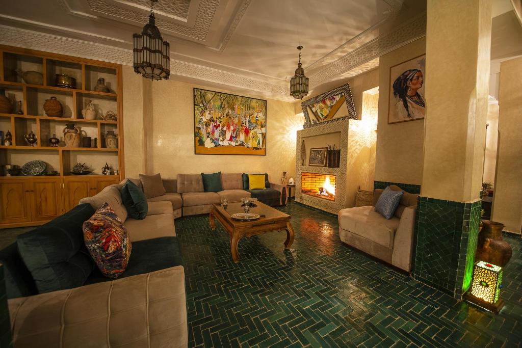 a living room with a couch and a table at Riad Atrium & Spa in Marrakesh