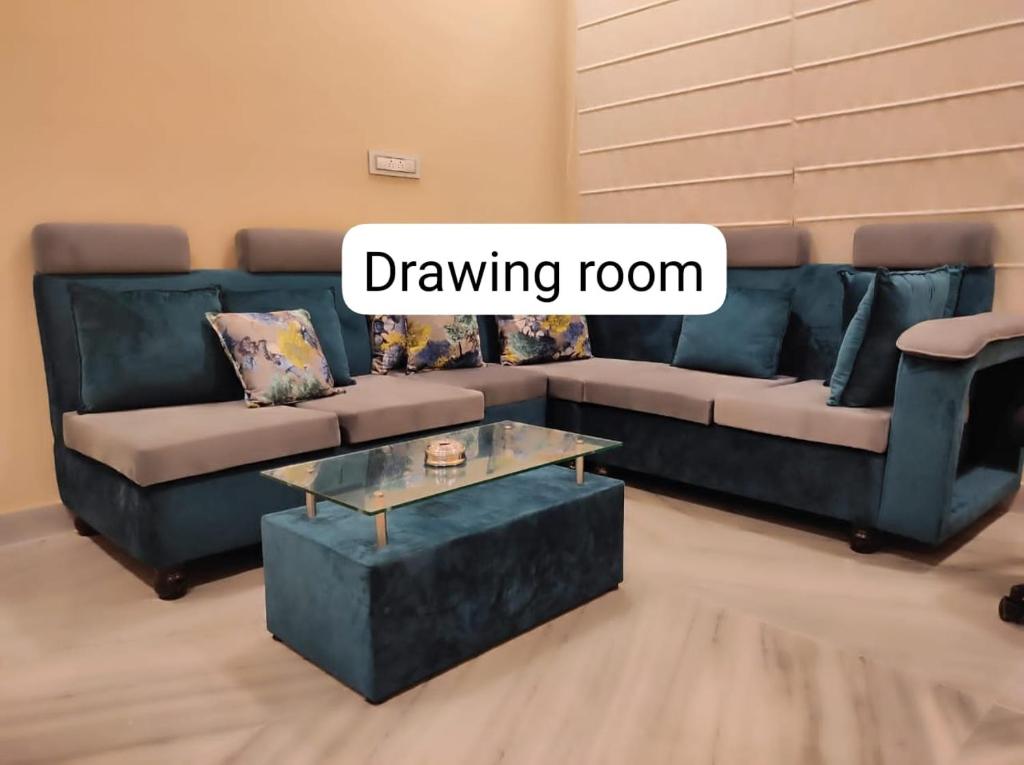 a living room with a blue couch and a drawing room at Vedic village aqua villa 3bhk in kolkata