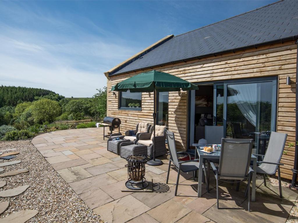 a patio with a table and chairs and an umbrella at 1 bed property in Durham CN208 in Lanchester