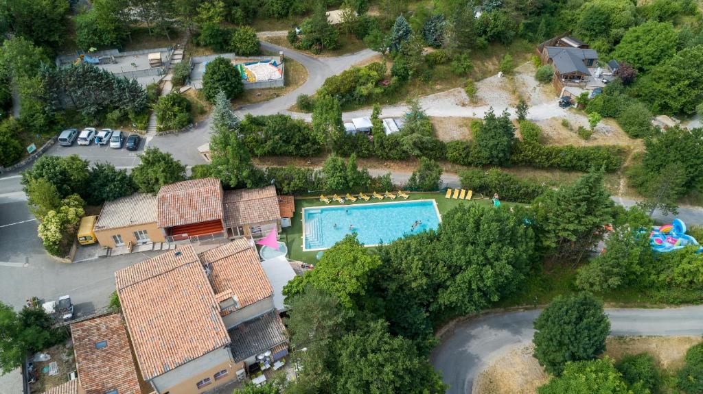 an overhead view of a house with a swimming pool at Camping les Princes d'Orange in Orpierre