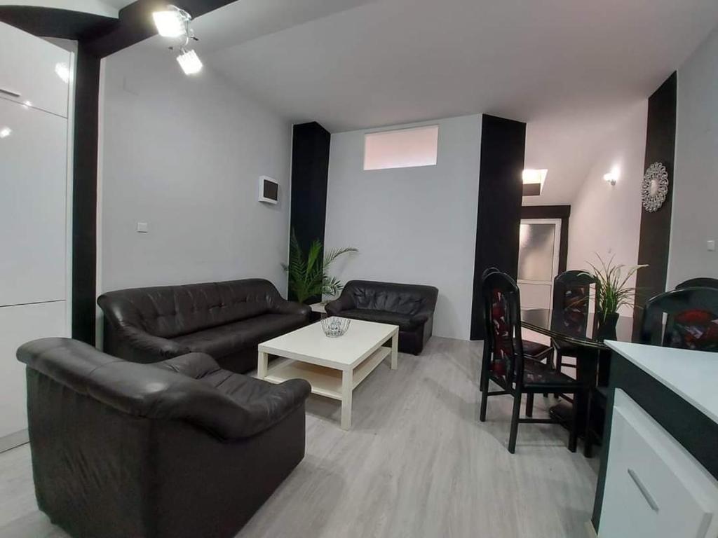 a living room with two couches and a table at Merter Apartments in Kavadarci