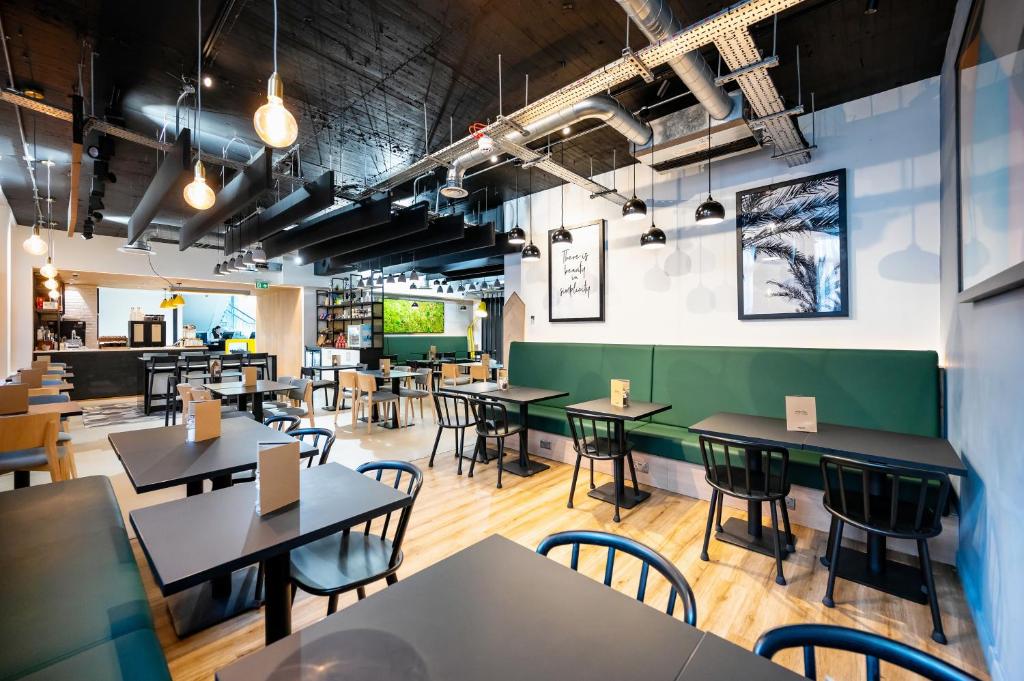 a restaurant with tables and chairs in a room at Staycity Aparthotels Liverpool Waterfront in Liverpool