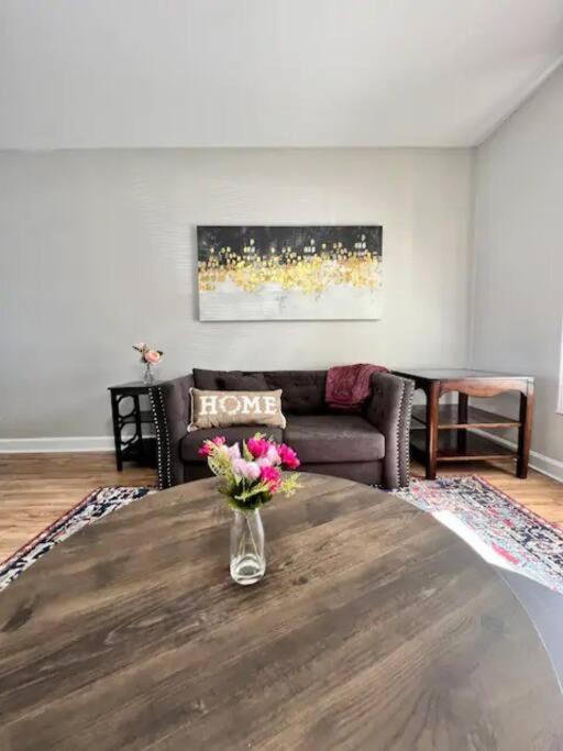 a living room with a vase of flowers on a table at Modern 2-story apt w/ high speed Wi-Fi & Patio! in Charlotte