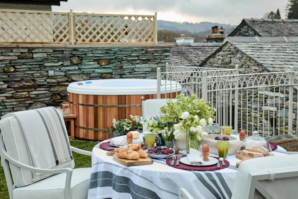a table with food and drinks on a patio at The Little Cottage in Chapel Stile
