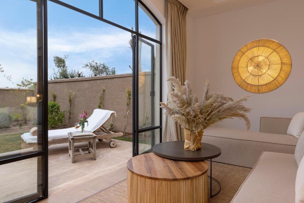 a living room with a couch and a table at Ksar Char-Bagh Small Luxury Hotels in Marrakesh