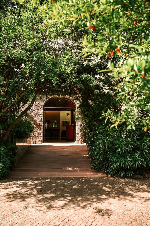 an entrance to a building with a wooden walkway at Hotel della baia - Negombo Parco Termale in Lacco Ameno