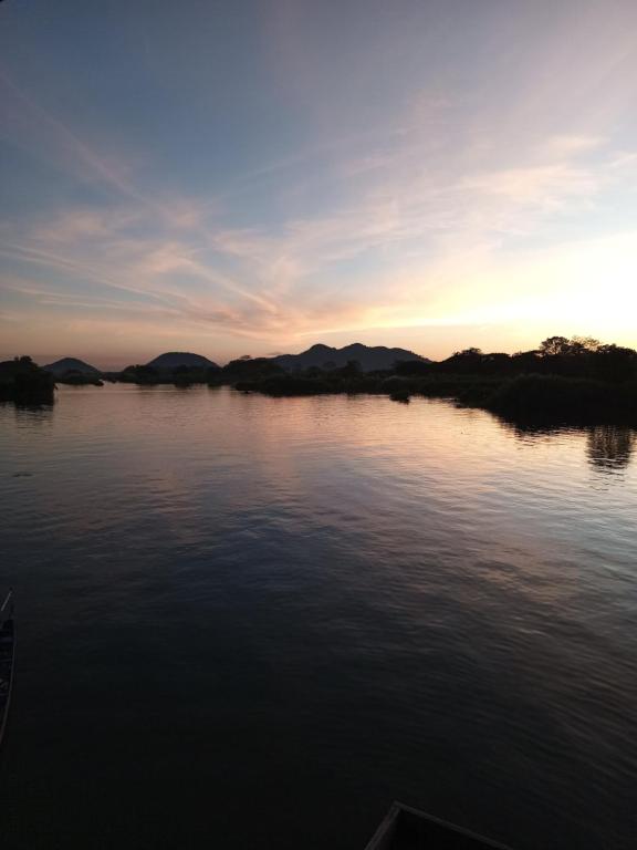 a view of a body of water at sunset at Sunset bar bungalows in Muang Không
