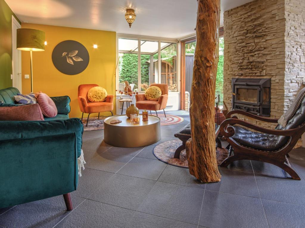 a living room with furniture and a fireplace at Bungalow AMNIS in Lanaken