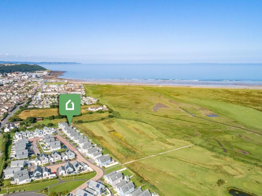 an aerial view of a resort with the beach at 4 Bed in Westward Ho 75358 in Northam