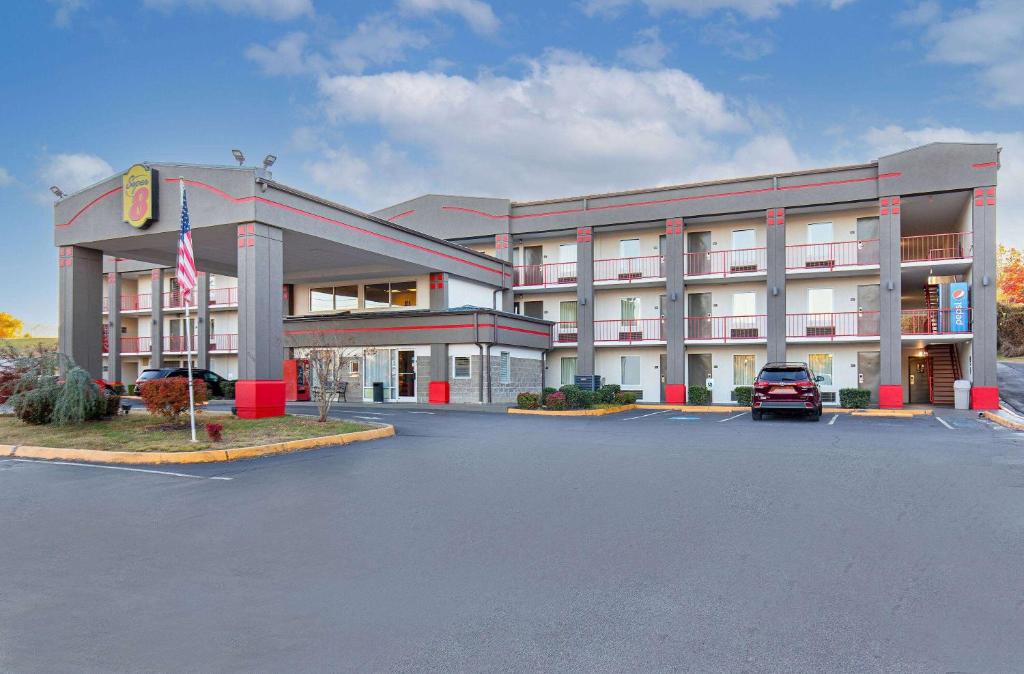a hotel with a car parked in a parking lot at Super 8 by Wyndham Kingsport in Kingsport