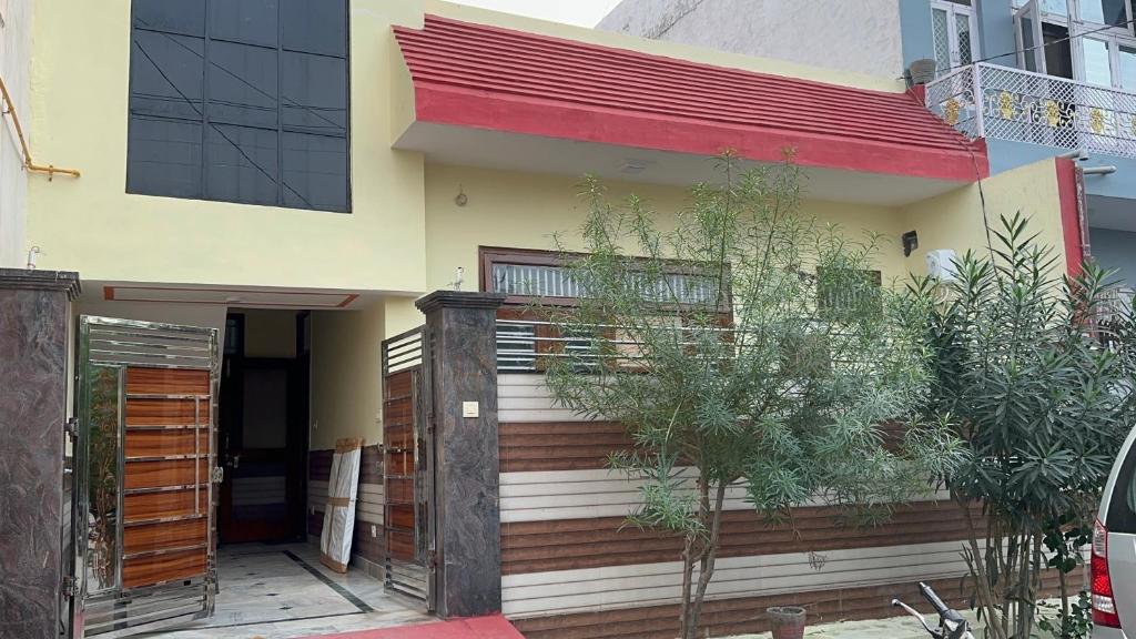 a house with a red roof at Vardan Homes in Mathura