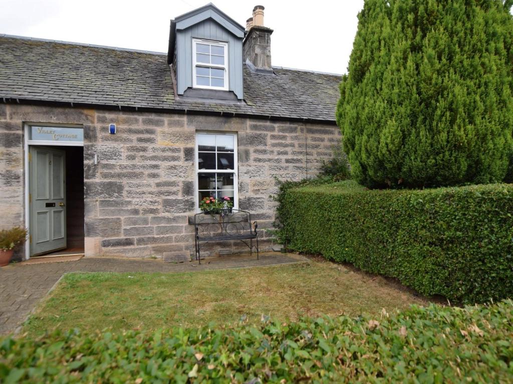 a building with a bench in front of it at 2 Bed in Edinburgh 83967 in Roslin