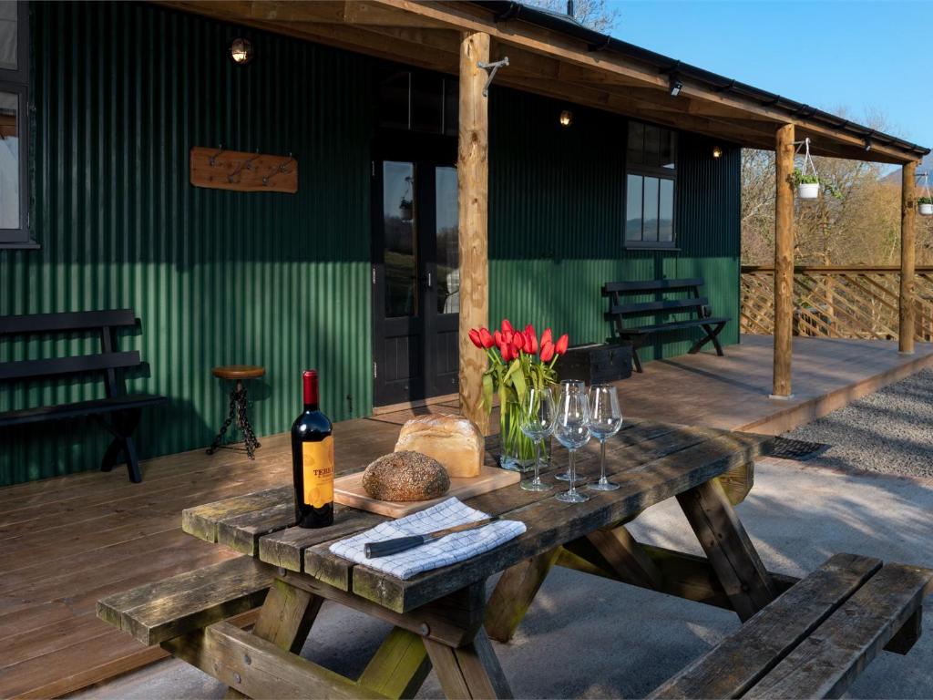a picnic table with a bottle of wine and glasses at 2 Bed in Pantygelli BN246 in Abergavenny