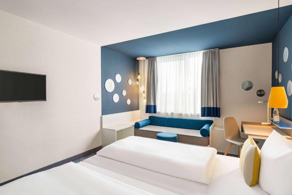 Postel nebo postele na pokoji v ubytování Vienna House Easy by Wyndham Landsberg