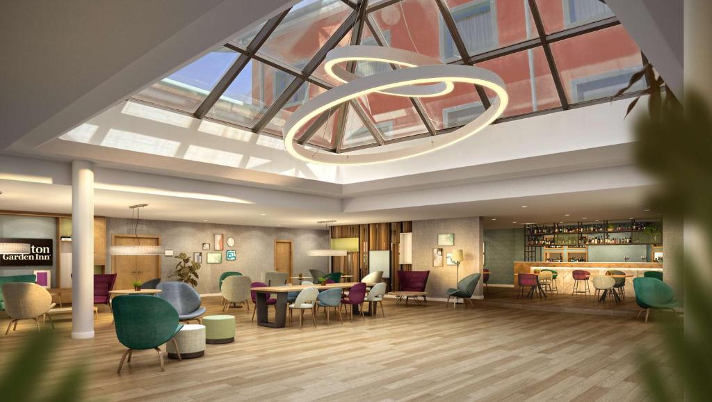 a rendering of a lobby with chairs and a chandelier at Hilton Garden Inn Milan Malpensa in Somma Lombardo