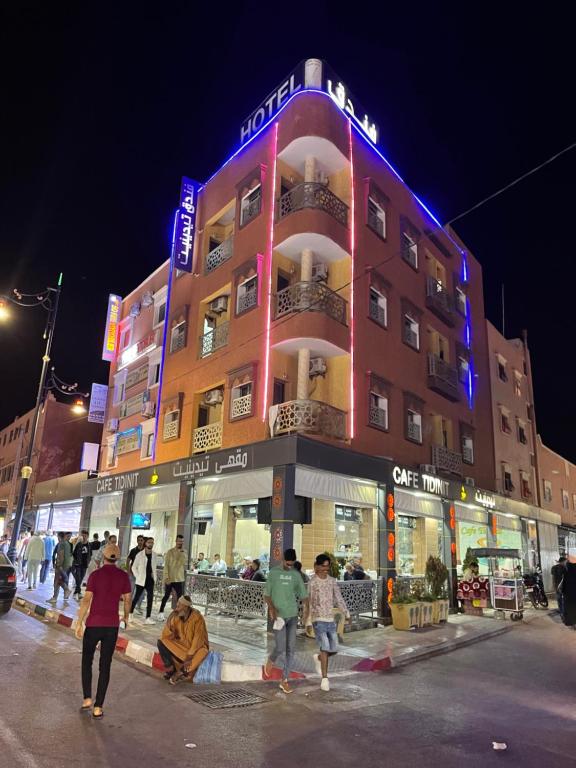 a group of people standing in front of a building at Hotel Tidinit in Guelmim