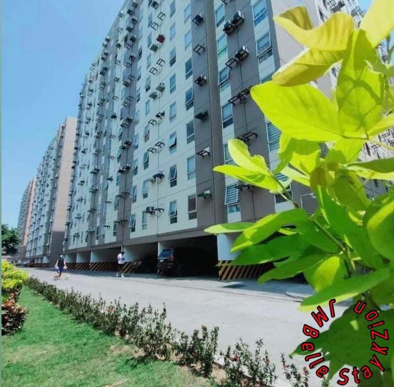 a large apartment building on the side of a street at 1-BR Condo Unit Urban Deca Homes Manila in Manila