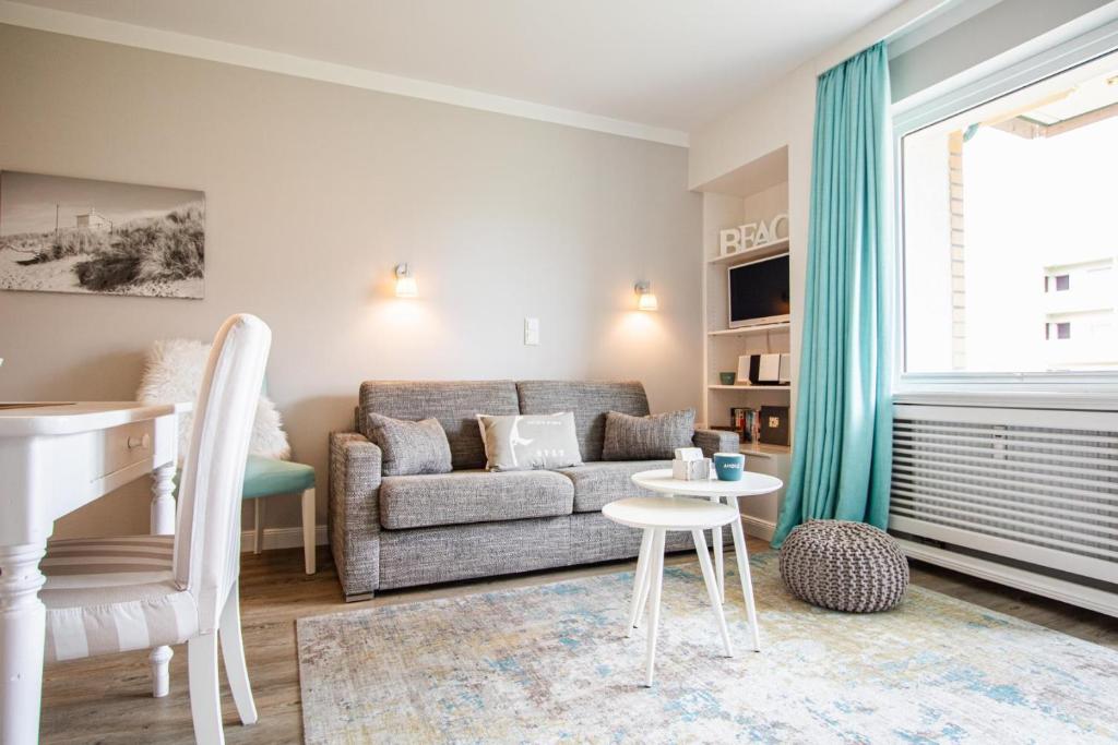 a living room with a couch and a table at App. Theo 50 in Westerland
