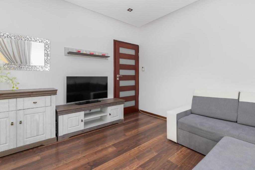 sala de estar con sofá y TV en Spacious Apartment in the centre of Gdańsk by Rent like home en Gdansk