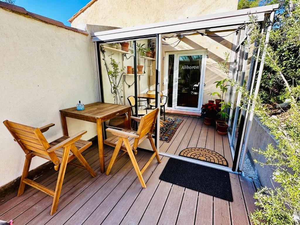 a patio with a table and chairs on a deck at B&B Les Têtes de Mules - Adults Only in Gémenos