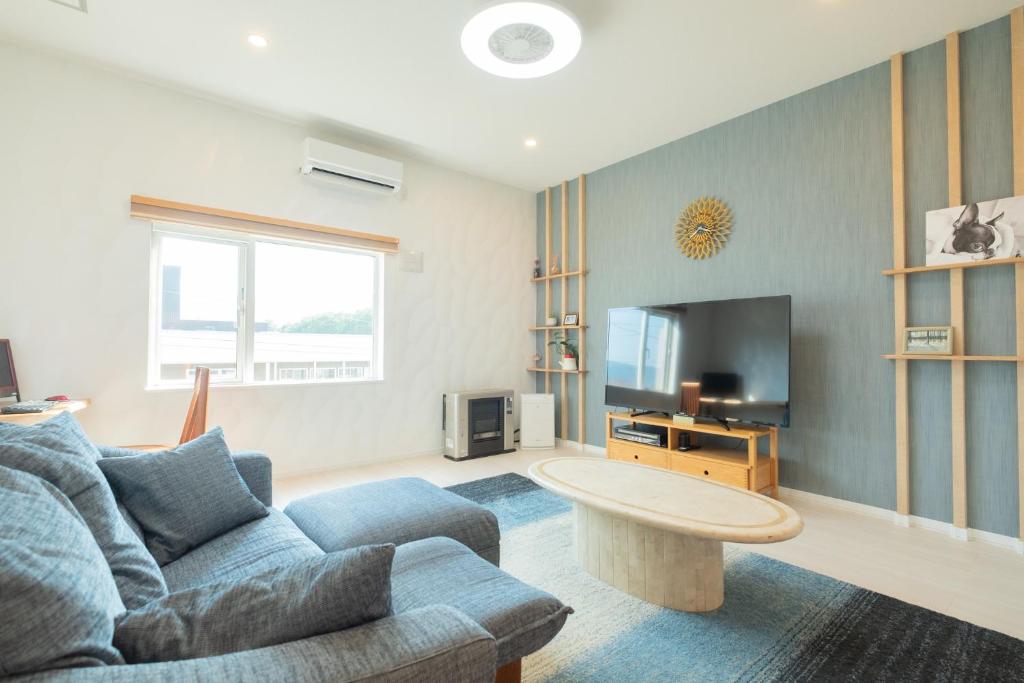 a living room with a couch and a tv at furano ski rabi in Furano
