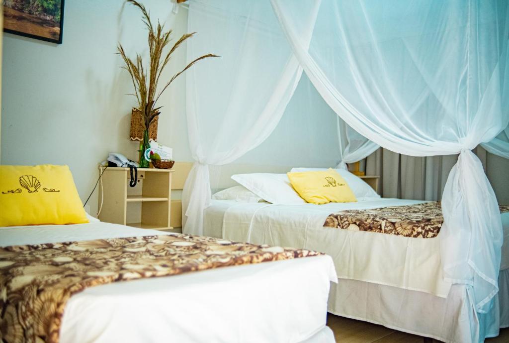 Cama ou camas em um quarto em Pousada Portal da Concha
