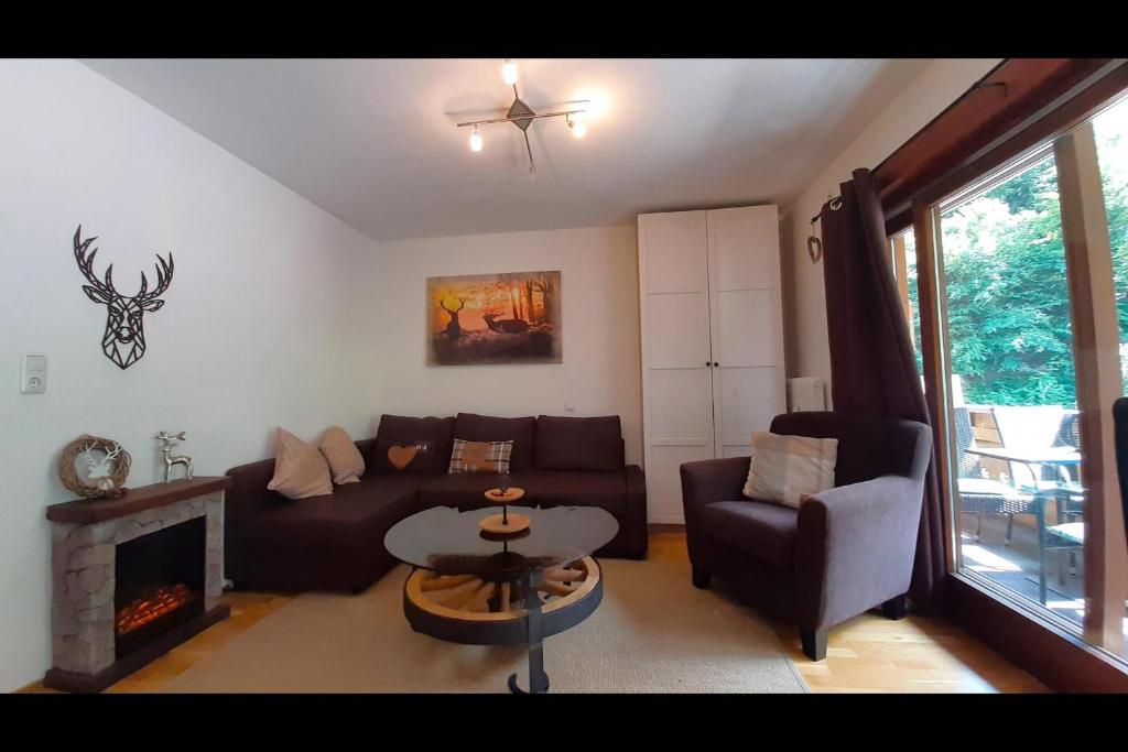 a living room with a couch and a fireplace at Ferienwohnung Tschagguns in Schruns-Tschagguns
