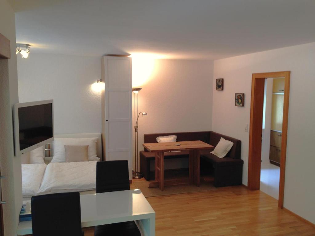 a living room with a bed and a table at Ferienwohnung Tschagguns in Schruns-Tschagguns