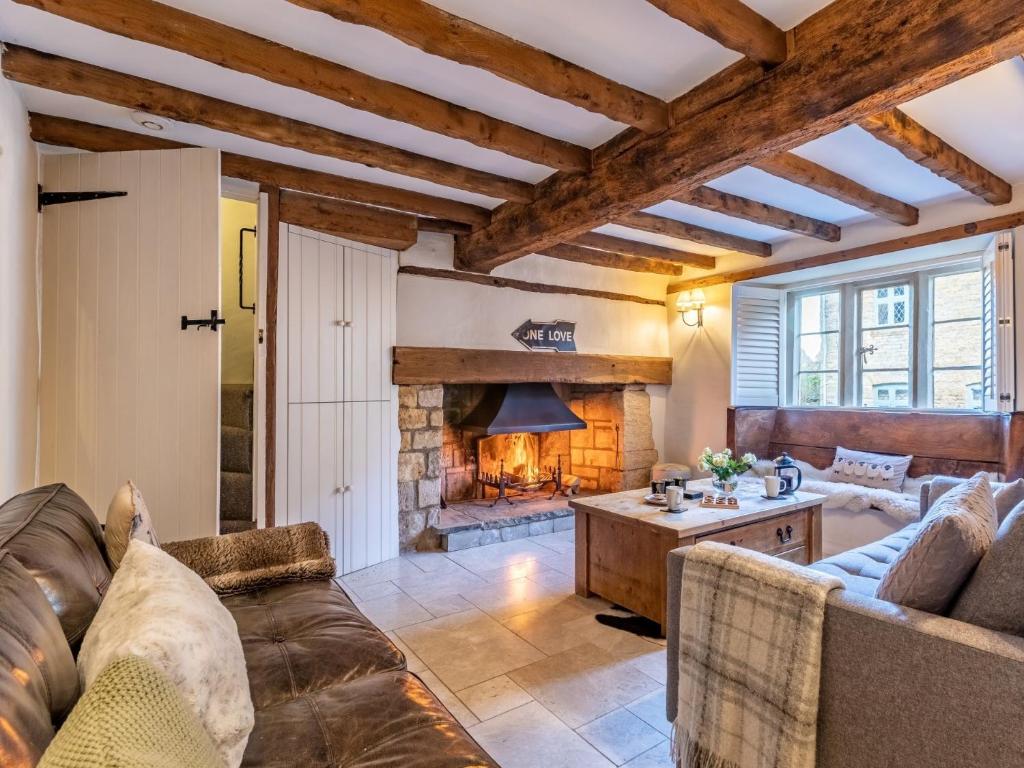 a living room with a couch and a fireplace at 3 bed in Stow-on-the-Wold 49965 in Lower Swell