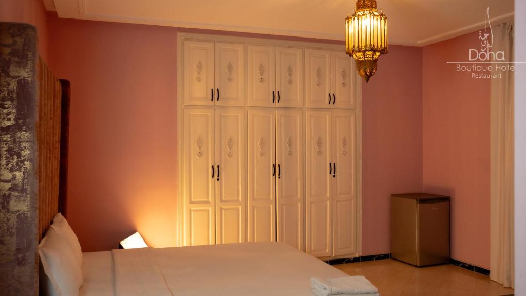 Postel nebo postele na pokoji v ubytování Aparthotel & Hotel Doha