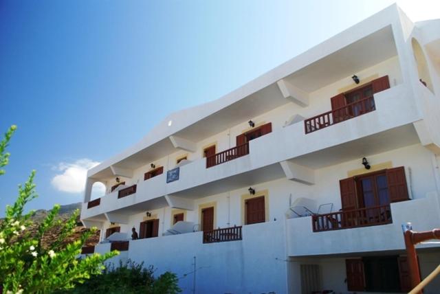 a white building with balconies on top of it at ZoeStudios-Arkasa in Arkasa