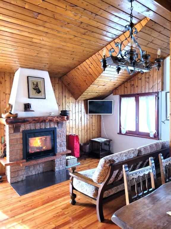 a living room with a fireplace and a couch at Peace and Lake Mountain Lake Iseo Hospitality in Bossico
